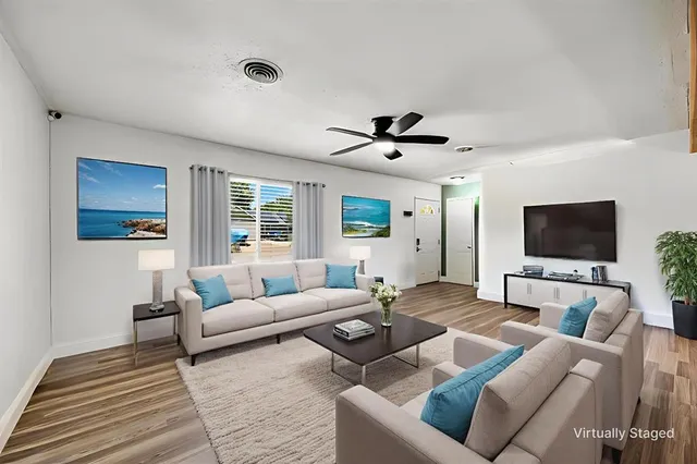 a living room with furniture and a flat screen tv