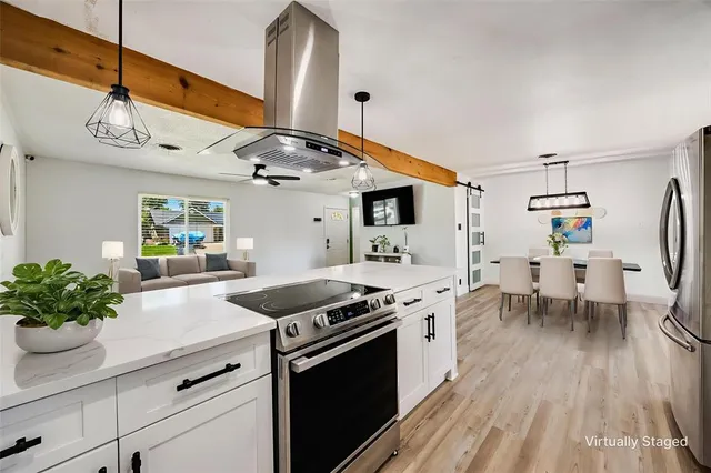 a kitchen with stainless steel appliances granite countertop a stove and a wooden floors