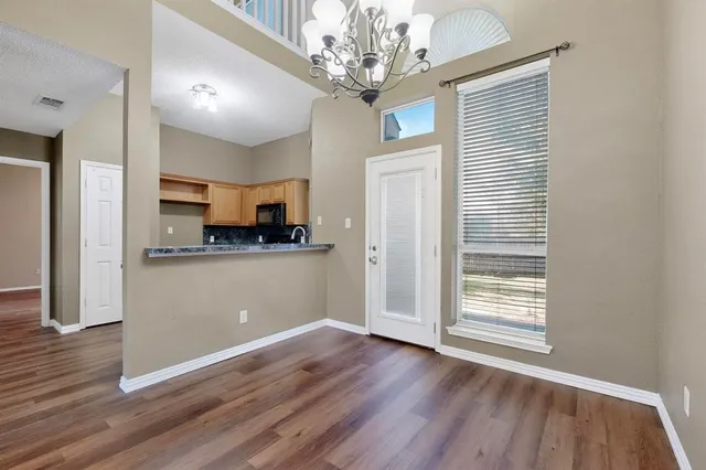 a view of a kitchen with wooden floor and a kitchen