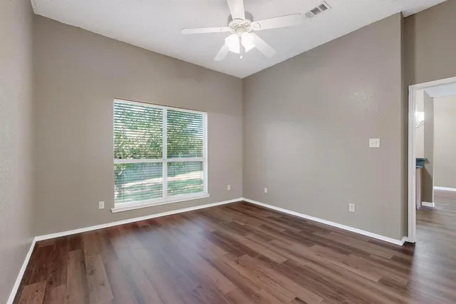 wooden floor in an empty room with a window