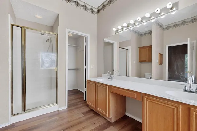 a spacious bathroom with a double vanity sink shower and a mirror