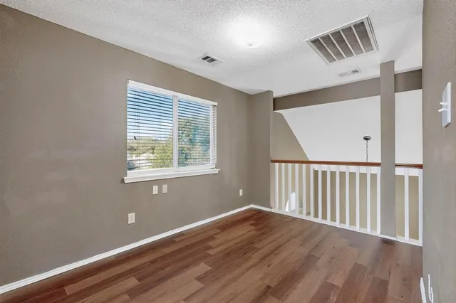 a view of hallway with wooden floor