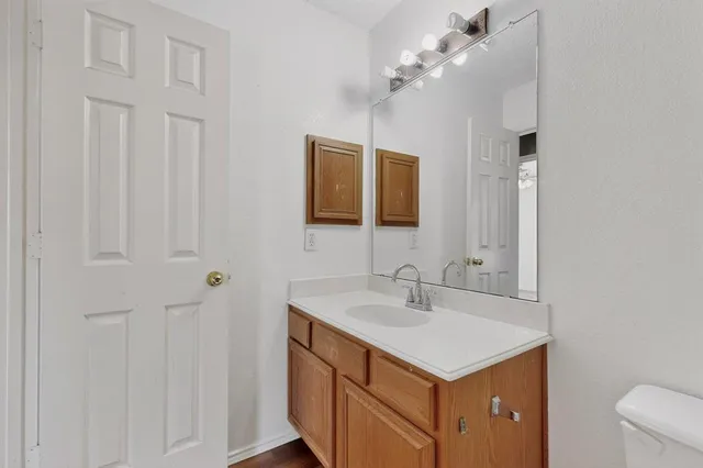 a bathroom with a sink vanity and a mirror
