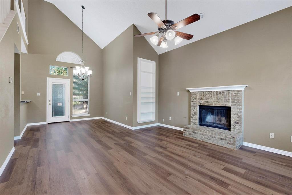 137 Walnut Lane Rockwall, TX 75032 - Photo 6 of 40 a view of an empty room with wooden floor fireplace and a window