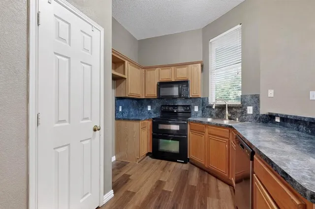 a kitchen with stainless steel appliances granite countertop a stove a sink and a granite counter tops