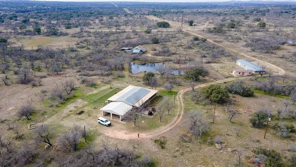 an aerial view of a backyard with trees