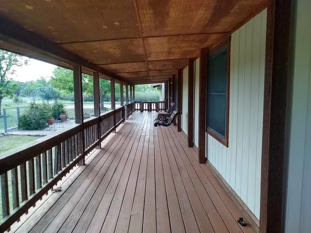 a view of a patio with table and chairs potted plants with lake view