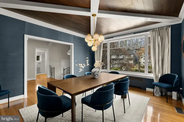 a kitchen with granite countertop cabinets a stove a dining table and chairs