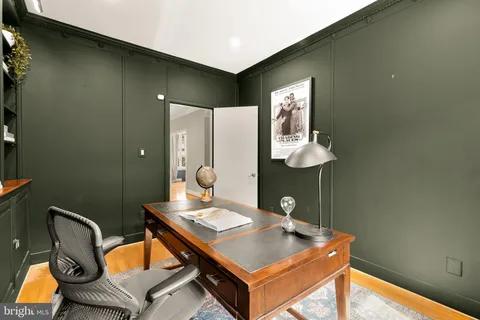 a bedroom with a large bed and a potted plant