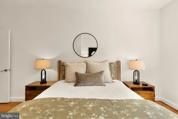 a bedroom with a bed and a large window