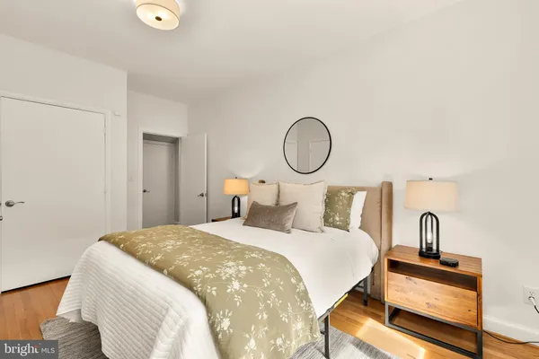 a spacious bedroom with a bed and a chandelier