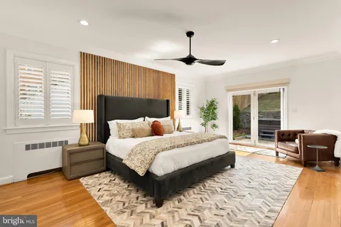 a bedroom with a bed and a large window