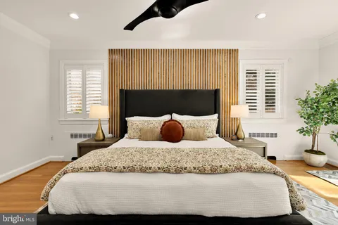 a spacious bedroom with a bed and a chandelier