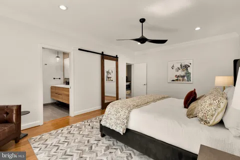 a living room with furniture a flat screen tv and a stove