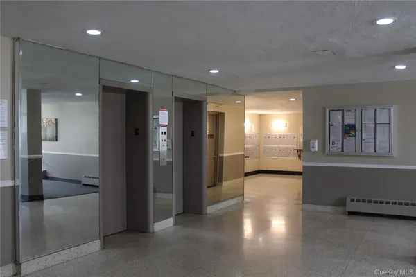 a view of hallway with a couch and a large window