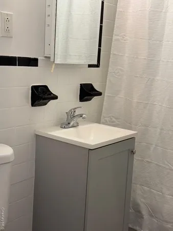 a bathroom with a sink toilet and mirror