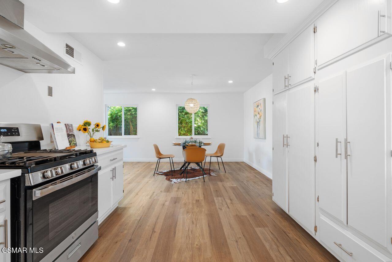3359 Ridden Street Camarillo, CA 93010 - Photo 14 of 30 a kitchen with stainless steel appliances a stove a sink a refrigerator cabinets and wooden floor