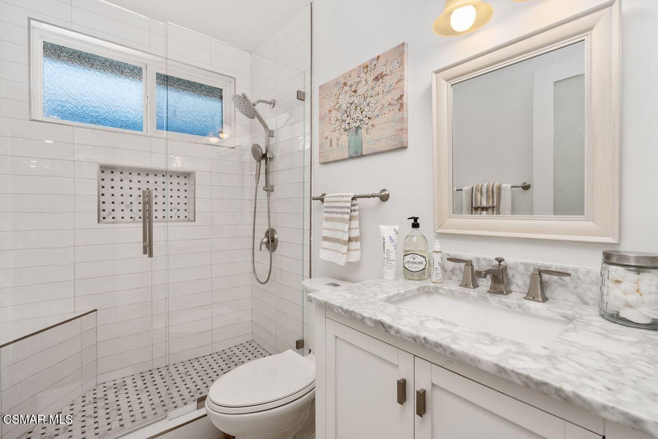 3359 Ridden Street Camarillo, CA 93010 - Photo 18 of 30 a bathroom with a granite countertop sink toilet a mirror and shower