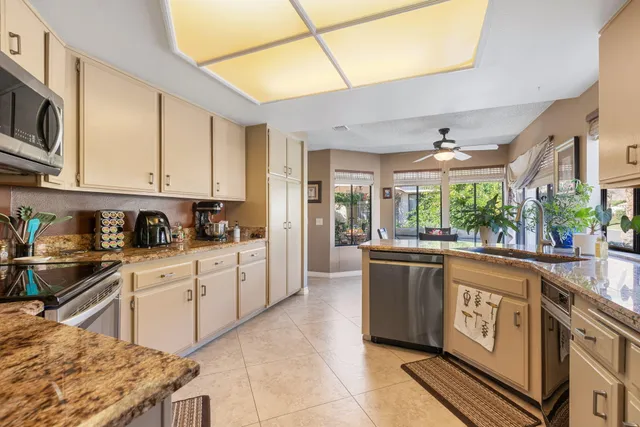 a dining room with furniture a chandelier and wooden floor