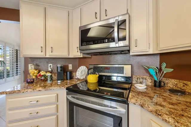 a view of living room filled with furniture and a chandelier