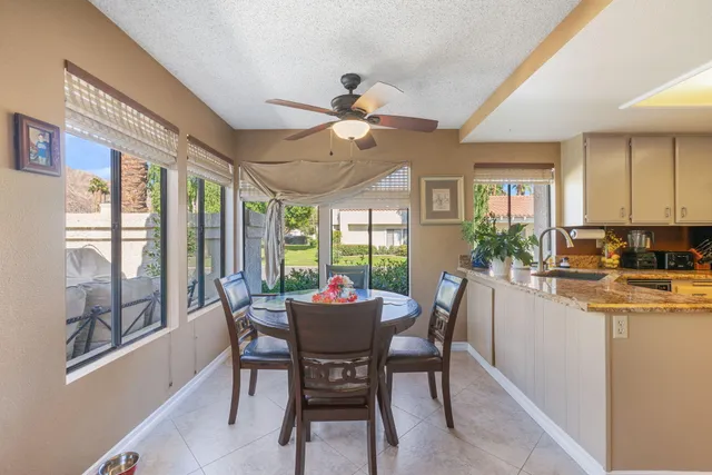 a bedroom with a bed and a flat tv screen on dresser