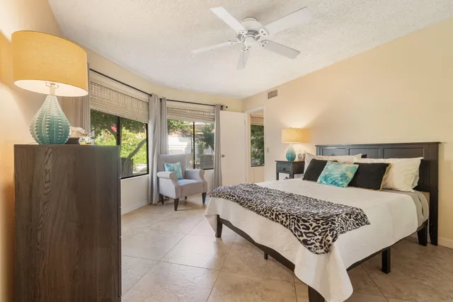 a view of a hallway with two windows and a yard