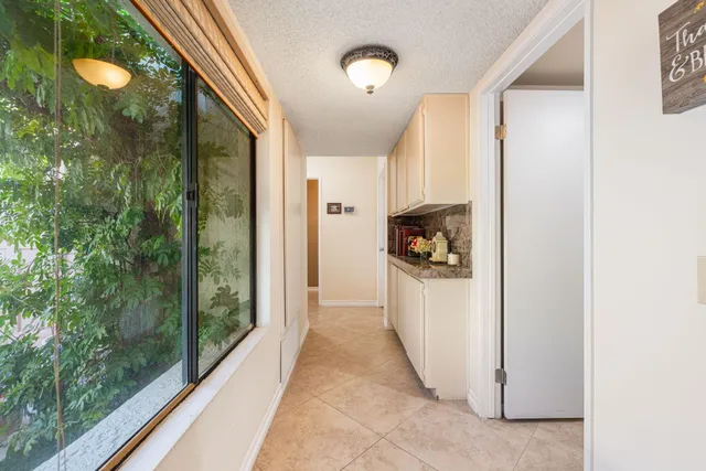 a bedroom with a bed and a lamp on dresser