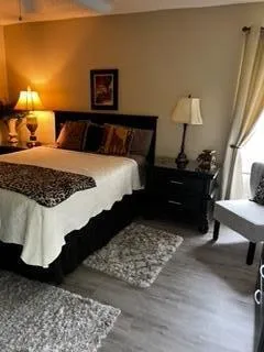 a view of a house with backyard and sitting area