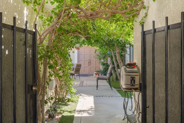 a view of a patio with table and chairs under an umbrella
