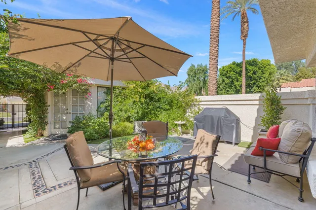 a view of a workspace room with furniture and potted plant