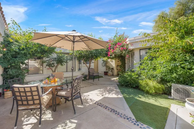 a living room with furniture a flat screen tv and a large window