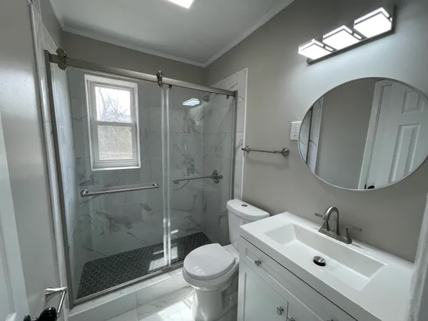 a bathroom with a sink toilet and shower