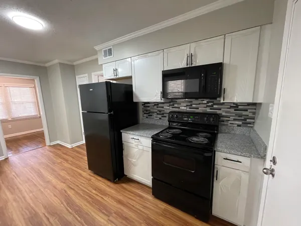 a kitchen with a refrigerator stove and microwave