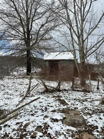 a view of a house with a yard covered in snow