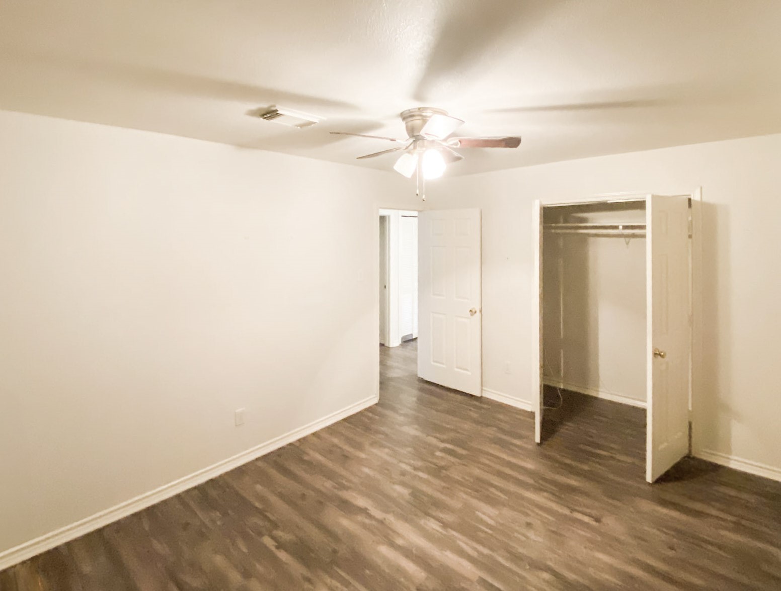 5006 Maxie Street Houston, TX 77007 - Photo 20 of 23 an empty room with wooden floor fan and windows