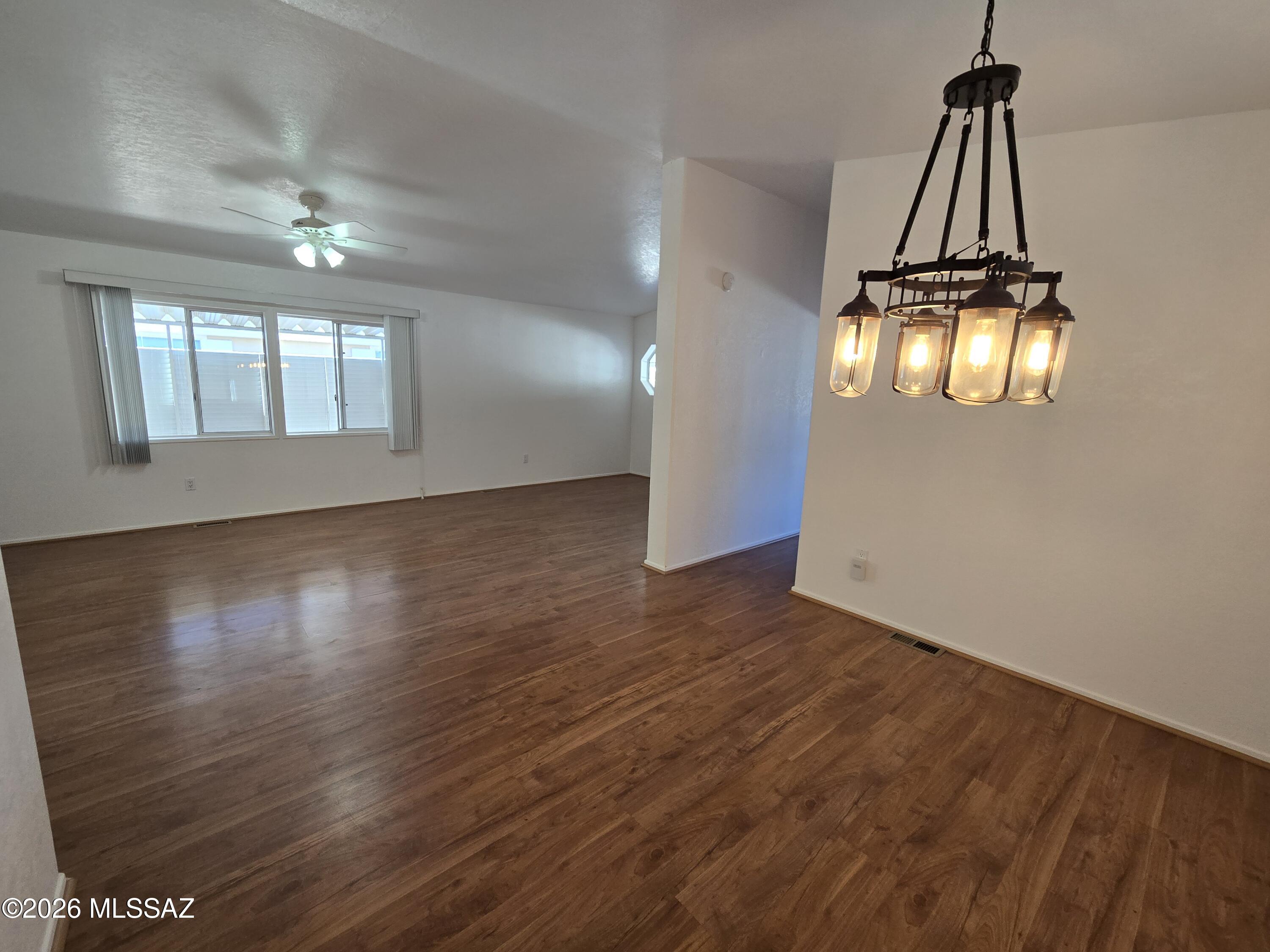 8401 South Kolb Road, Unit 61 Tucson, AZ 85756 - Photo 18 of 23 a view of empty room with wooden floor and window