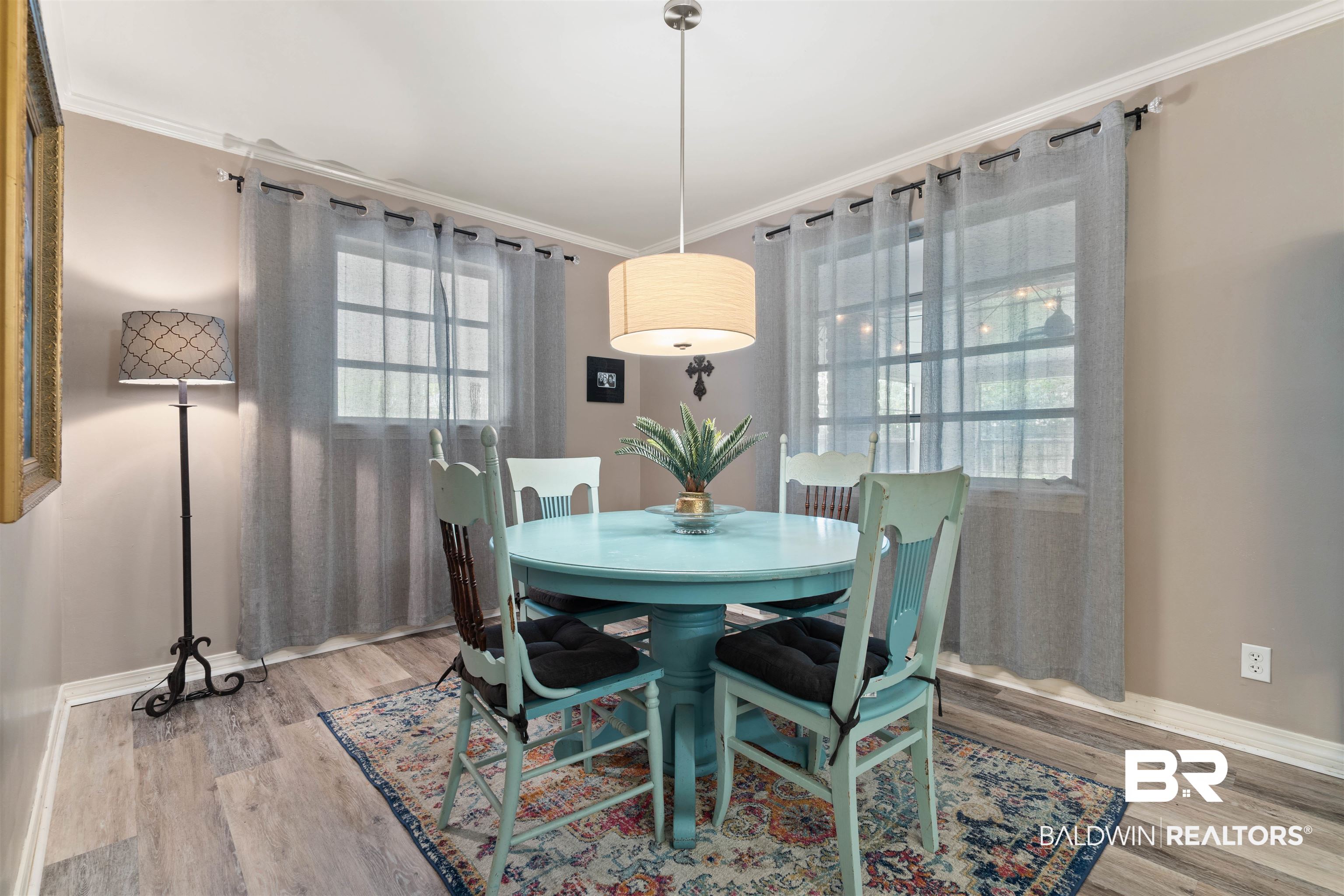 4051 East Canal Circle Mobile, AL 36619 - Photo 15 of 32 Dining area featuring a healthy amount of sunlight, hardwood / wood-style flooring, and crown molding