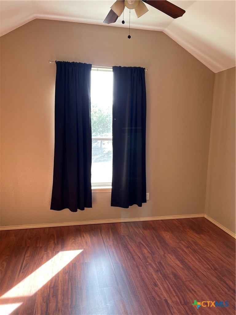 234 Star Grass, Unit 2B Spring Branch, TX 78070 - Photo 25 of 30 an empty room with wooden floor and windows