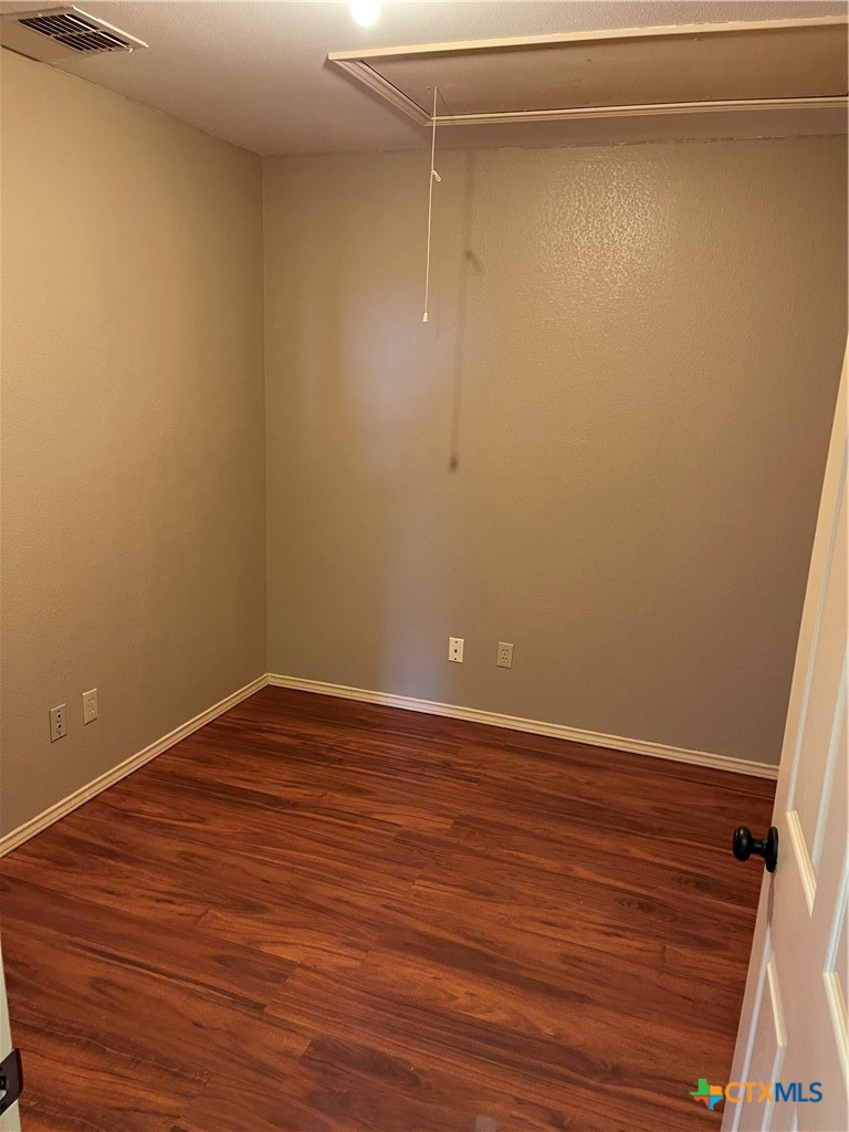 234 Star Grass, Unit 2B Spring Branch, TX 78070 - Photo 27 of 30 a view of an empty room with wooden floor and a window