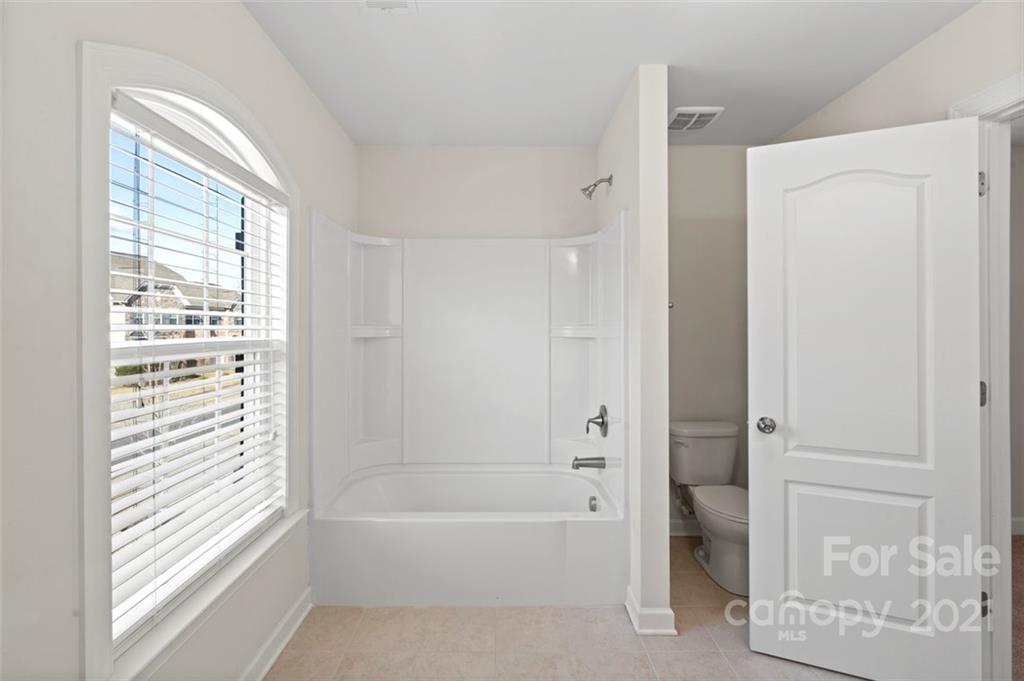 4331 Oxford Mill Road Waxhaw, NC 28173 - Photo 34 of 48 a bathroom with a bathtub and a shower