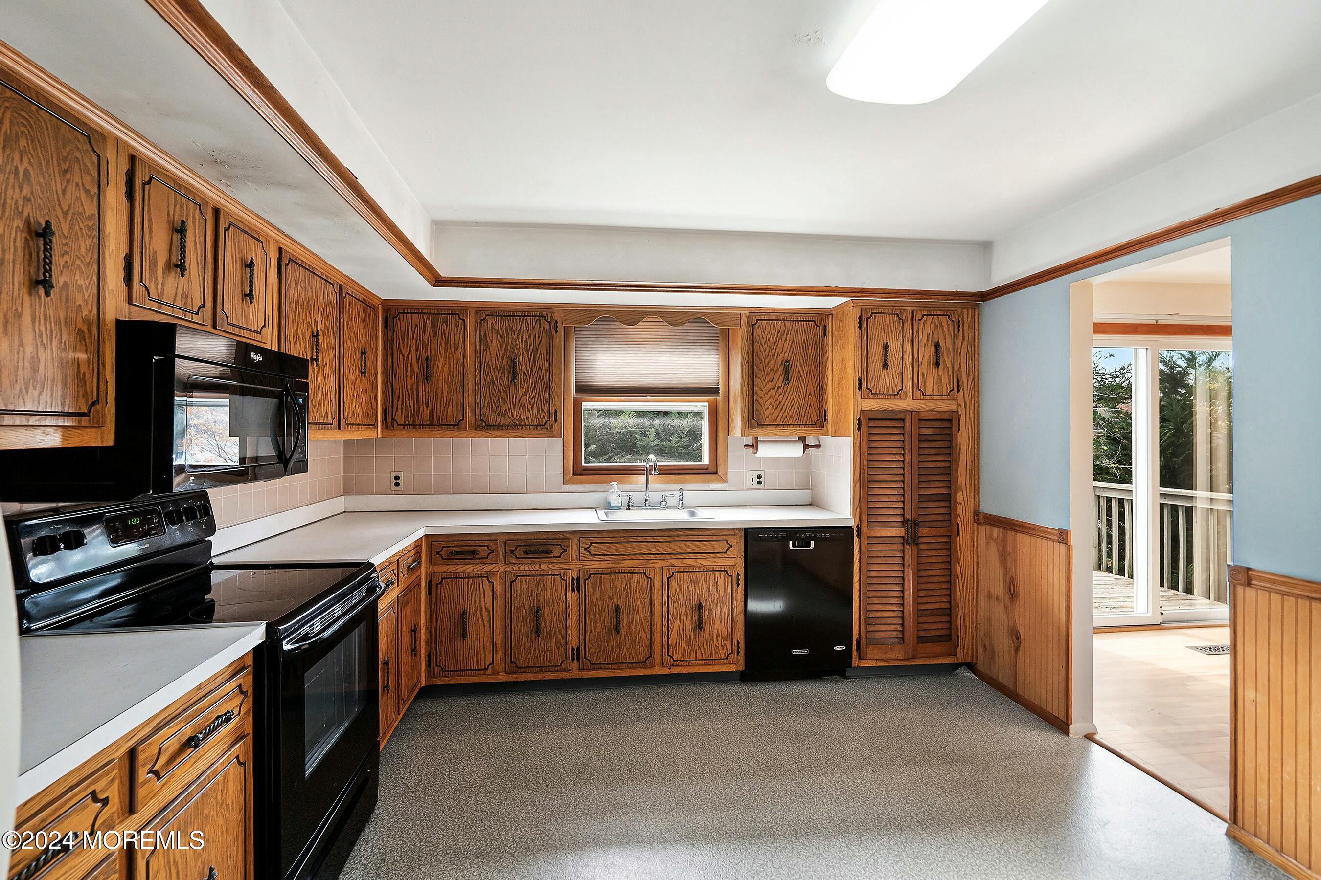 1107 Manito Road Manasquan, NJ 08736 - Photo 6 of 27 a large kitchen with stainless steel appliances granite countertop a stove and a sink