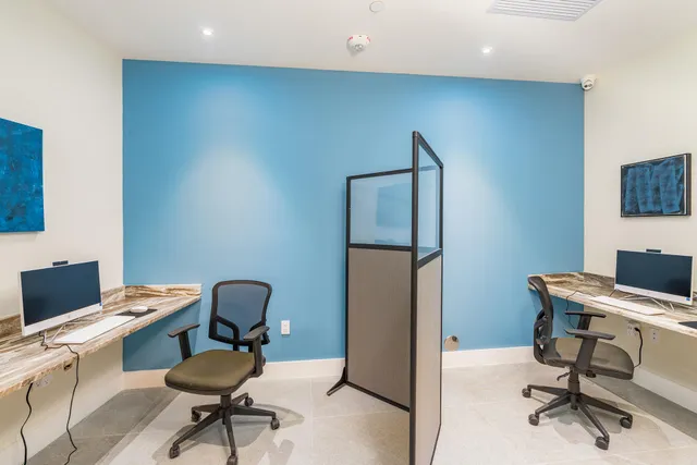 a view of a workspace with furniture