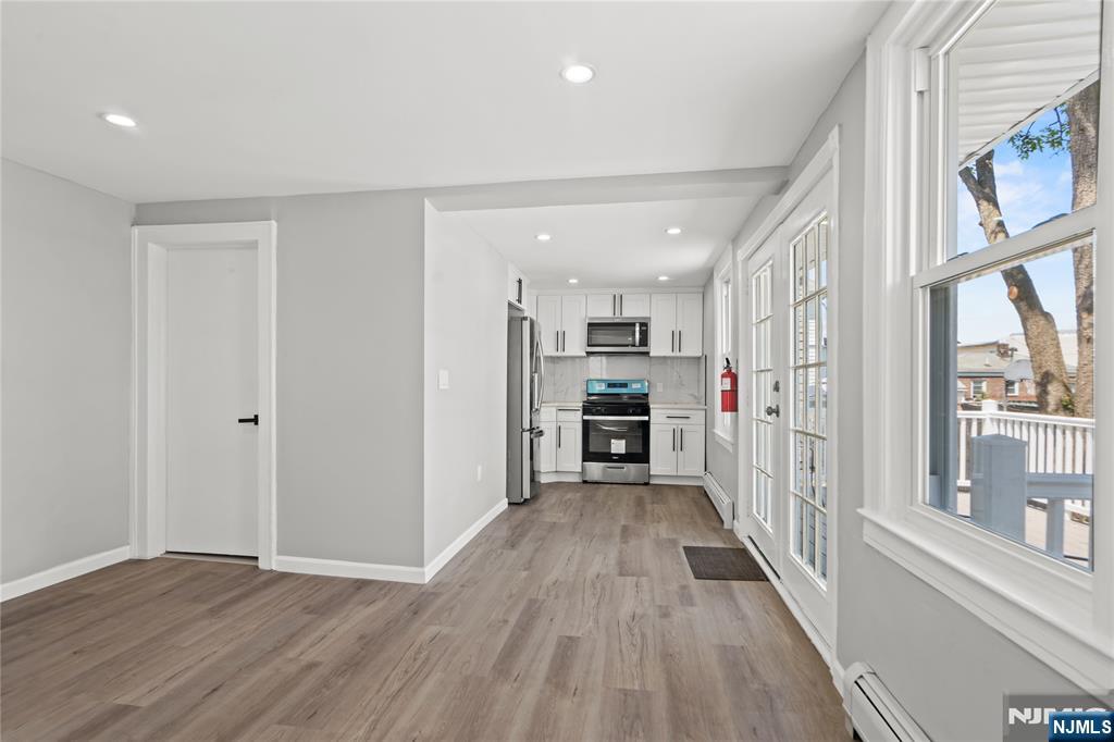 a view of a hallway with wooden floor