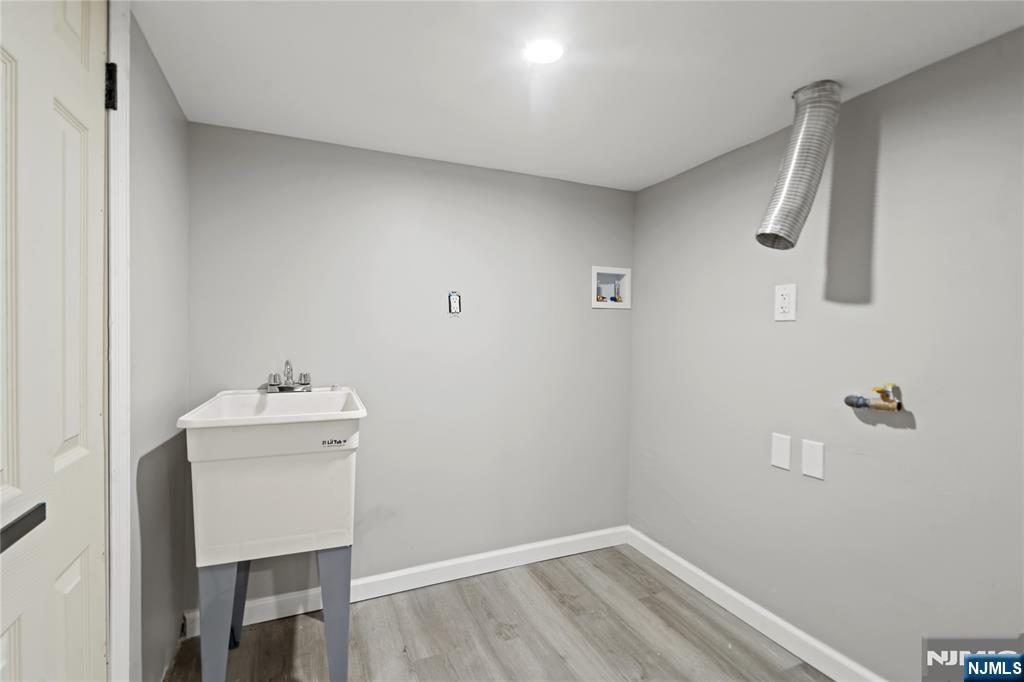 190 Washington Avenue Hackensack, NJ 07601 - Photo 14 of 20 a bathroom with a sink a light fixture and a toilet