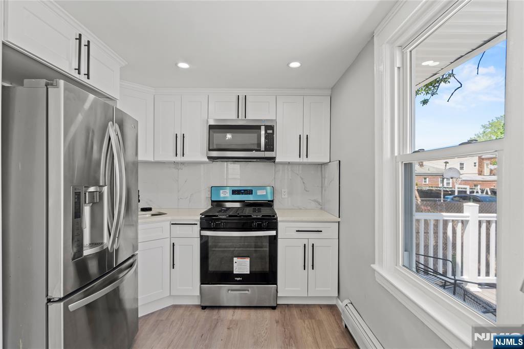 190 Washington Avenue Hackensack, NJ 07601 - Photo 3 of 20 a kitchen with stainless steel appliances a refrigerator stove and sink