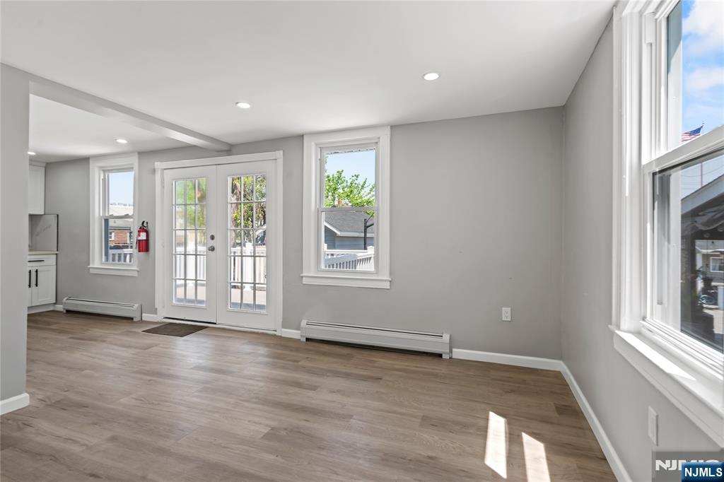 190 Washington Avenue Hackensack, NJ 07601 - Photo 4 of 20 an empty room with wooden floor and windows