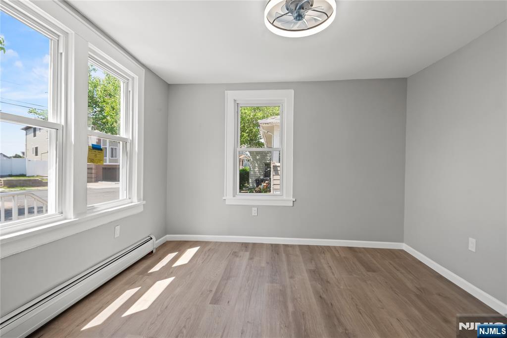190 Washington Avenue Hackensack, NJ 07601 - Photo 6 of 20 a view of empty room with wooden floor and fan