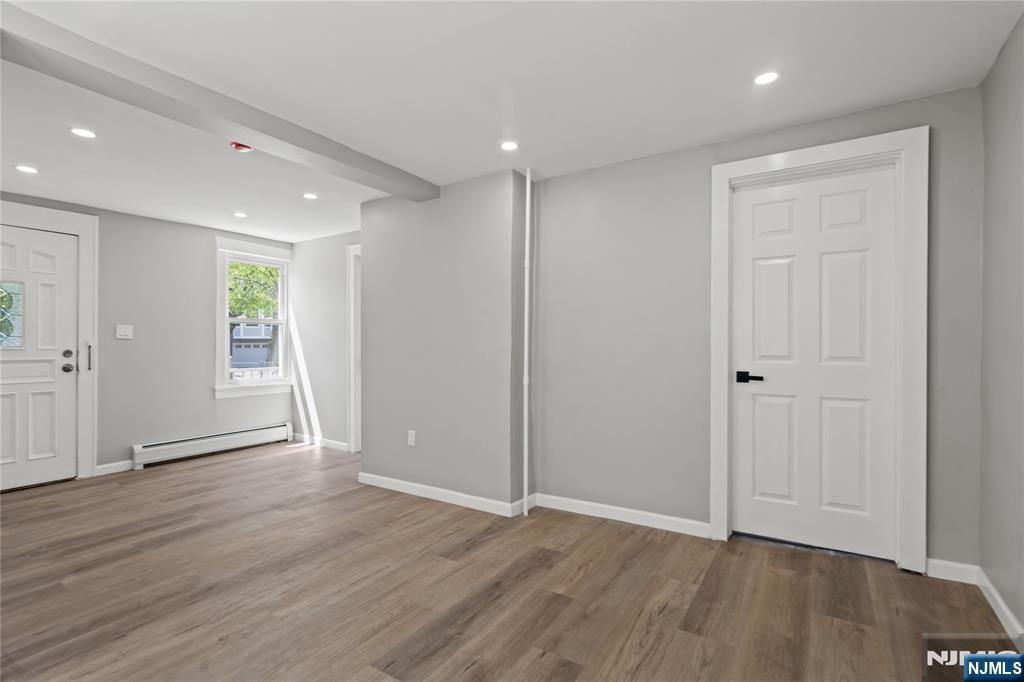 190 Washington Avenue Hackensack, NJ 07601 - Photo 7 of 20 a view of an empty room with wooden floor and a window