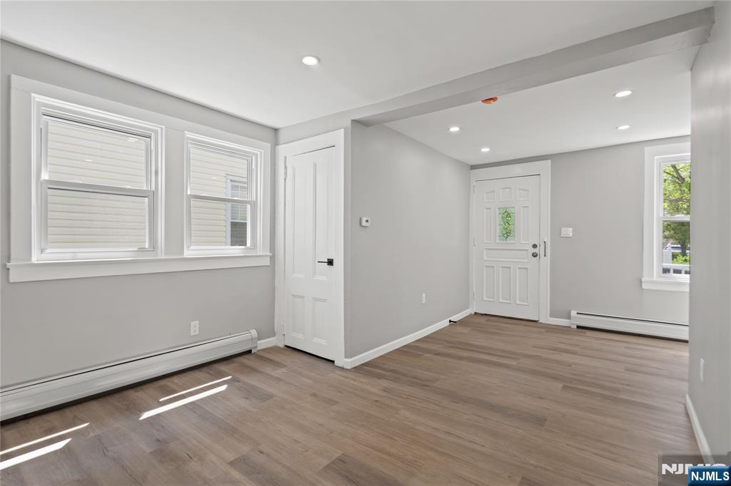 190 Washington Avenue Hackensack, NJ 07601 - Photo 8 of 20 a view of an empty room with wooden floor and windows