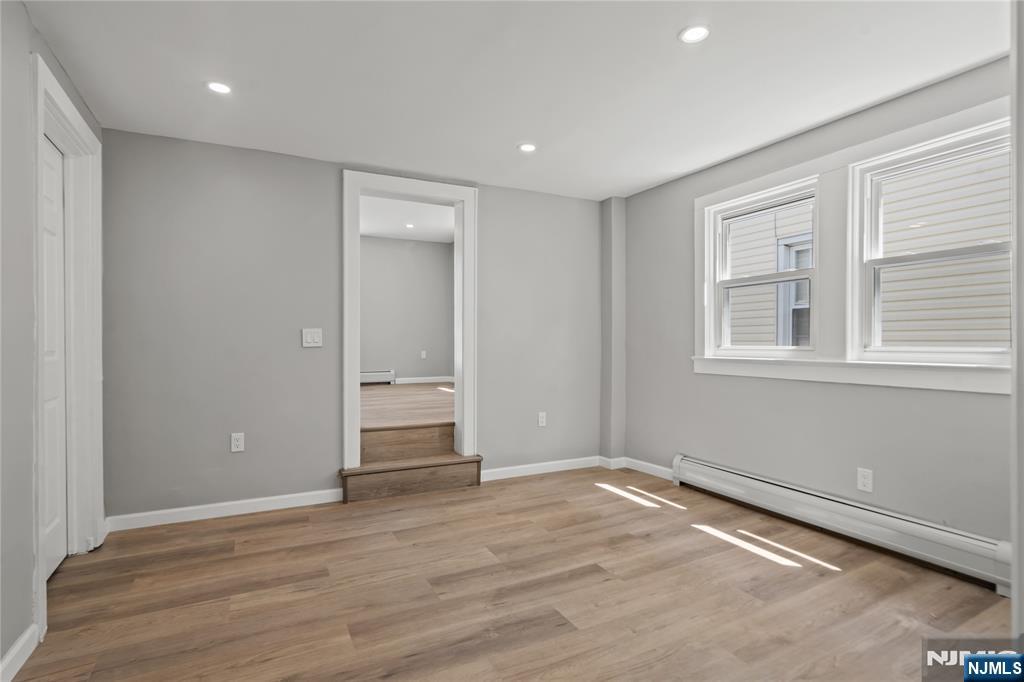 190 Washington Avenue Hackensack, NJ 07601 - Photo 9 of 20 a view of empty room with wooden floor and fan